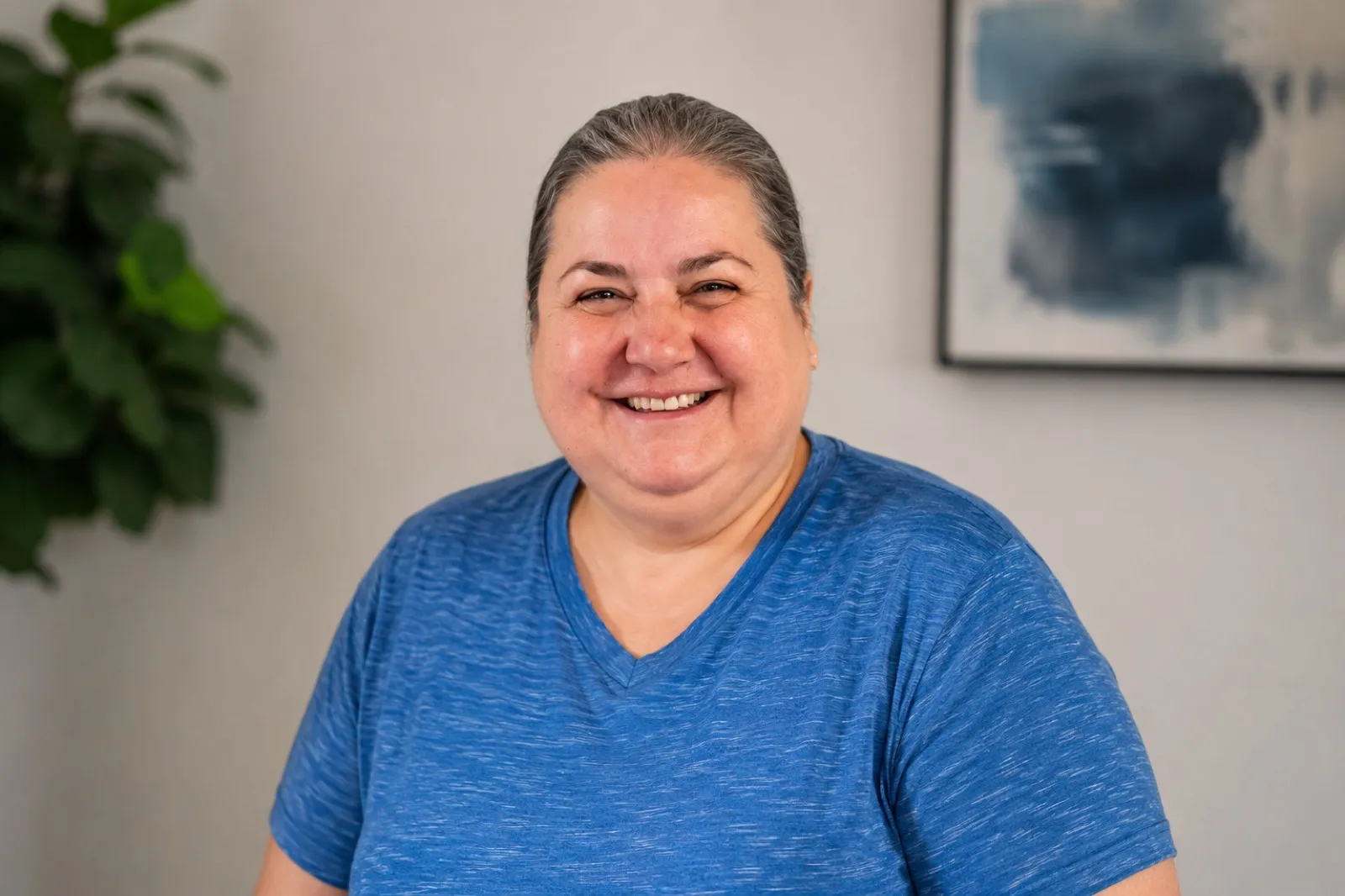 Irma, owner of De La Mora Cleaning Services, smiling warmly in a blue shirt